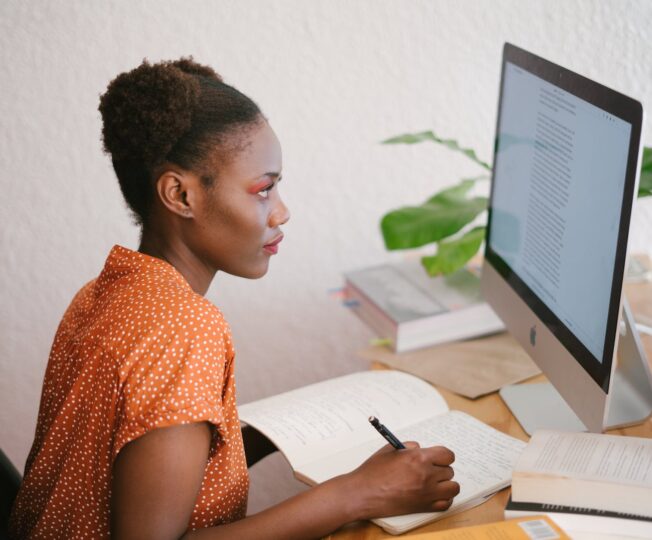 photo of woman looking on computer